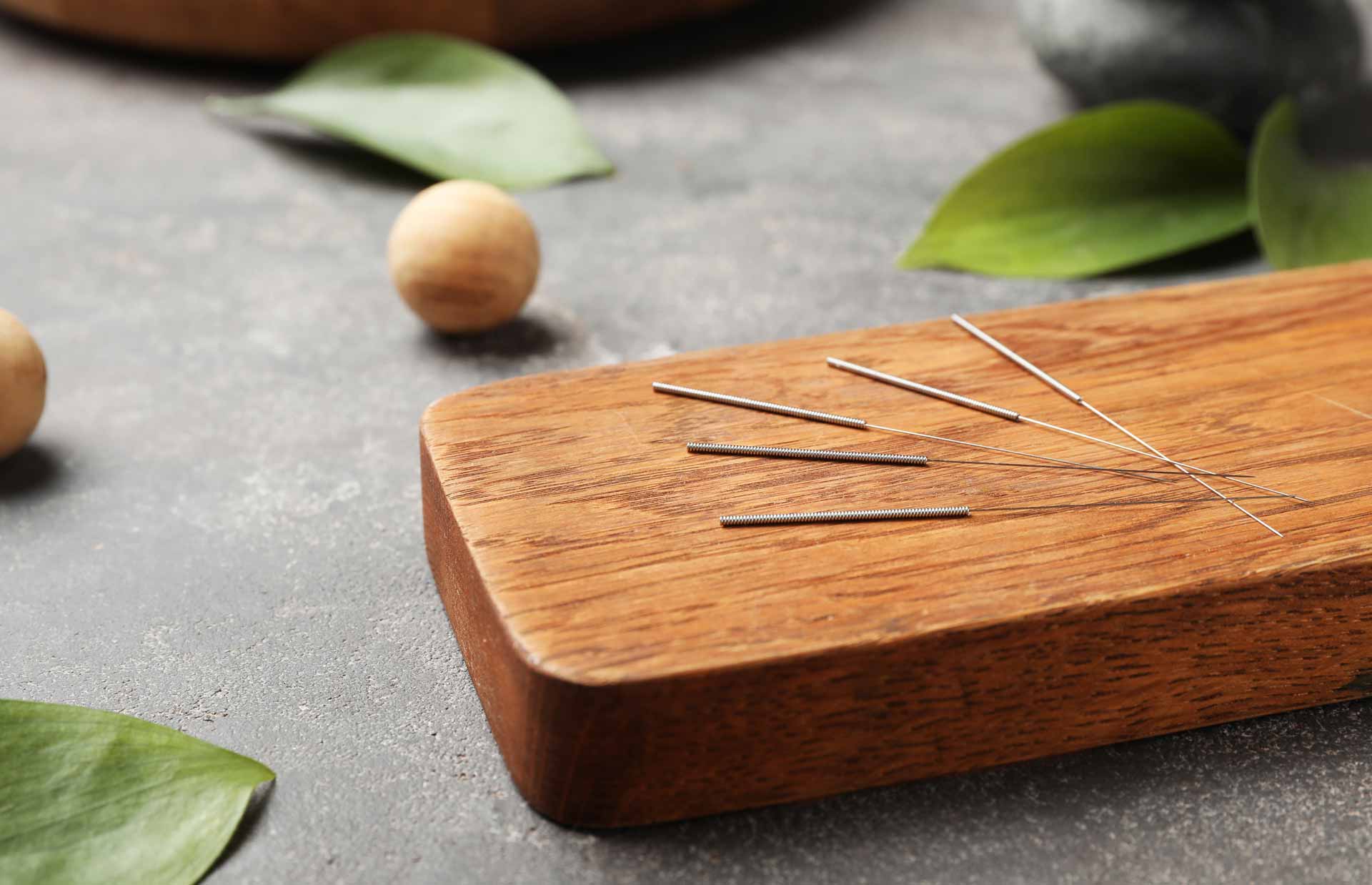 Acupuncture needles on wooden tray